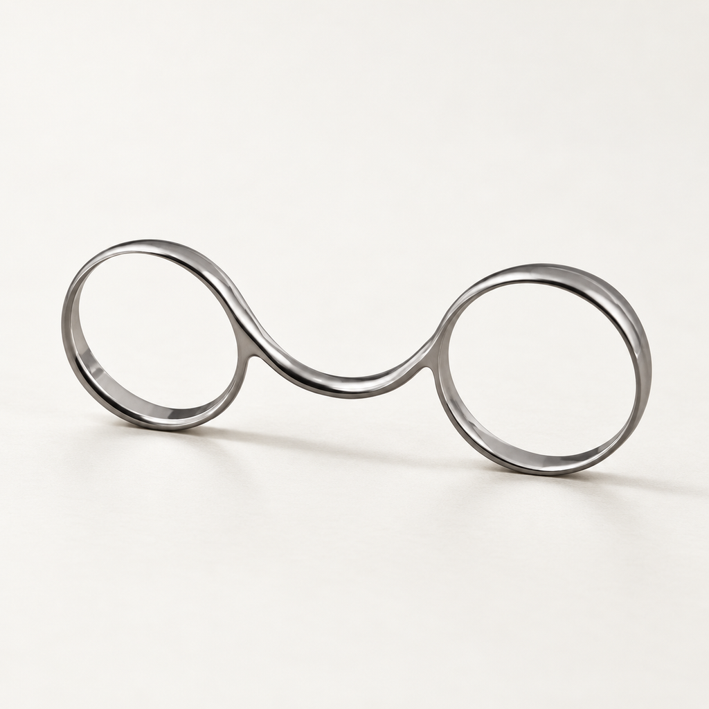 2½ buddy ring in polished silver-tone metal with two loops joined by a curved bridge, studio view