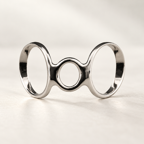 Boutonniere finger splint in polished silver-tone metal with two large open loops and a smaller center loop, studio view