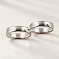 Buddy ring in polished silver-tone metal made of two connected bands, studio view