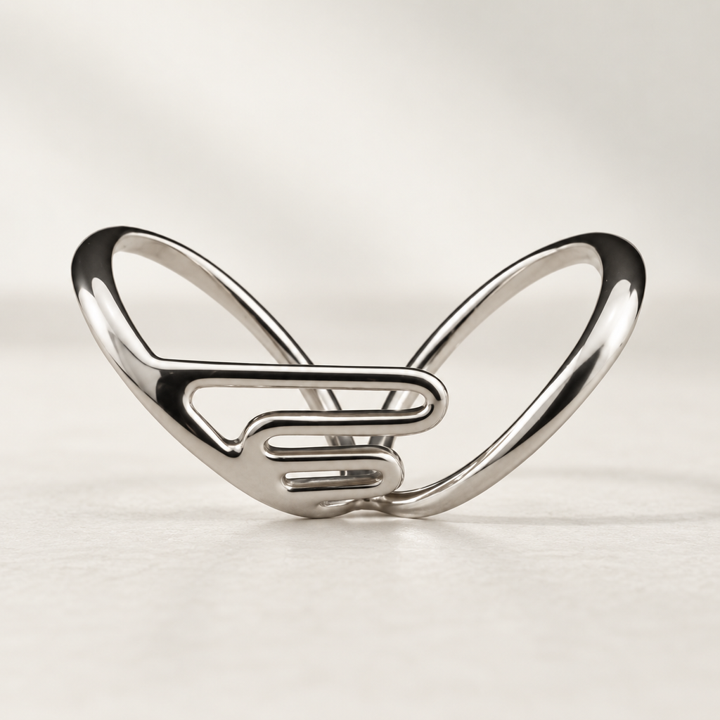 Lateral support finger splint in polished silver-tone metal with an open ladder-style frame, studio view