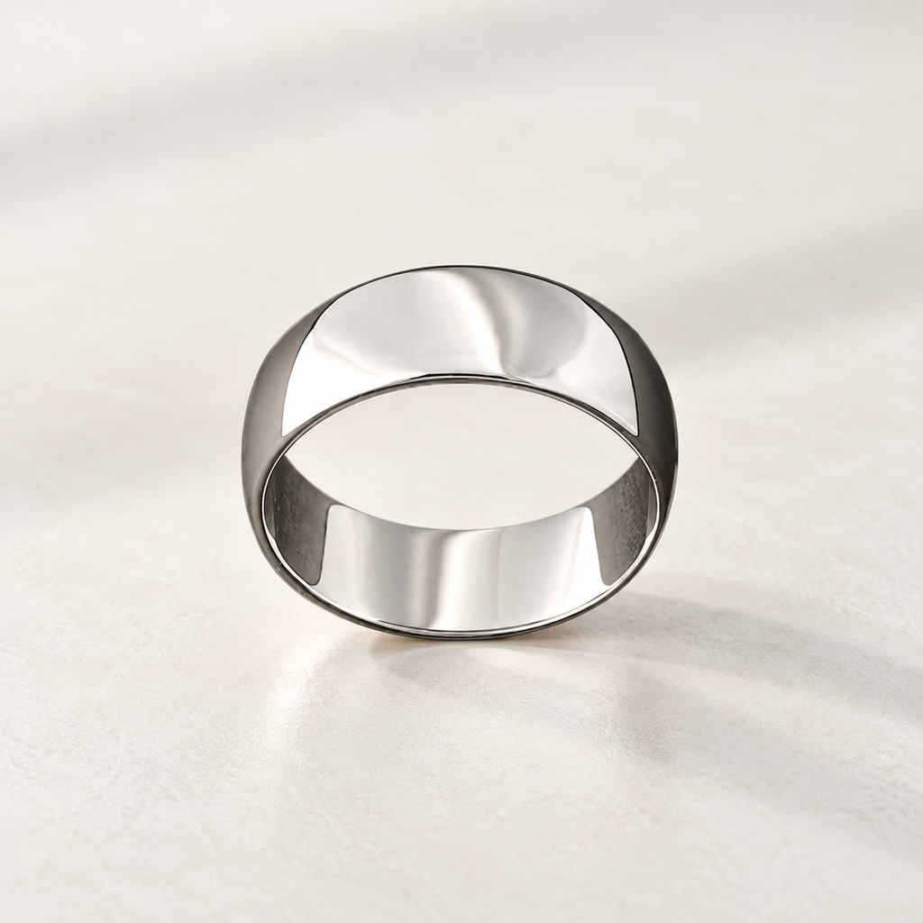 Pulley ring in polished silver-tone metal, a wide smooth band, studio view